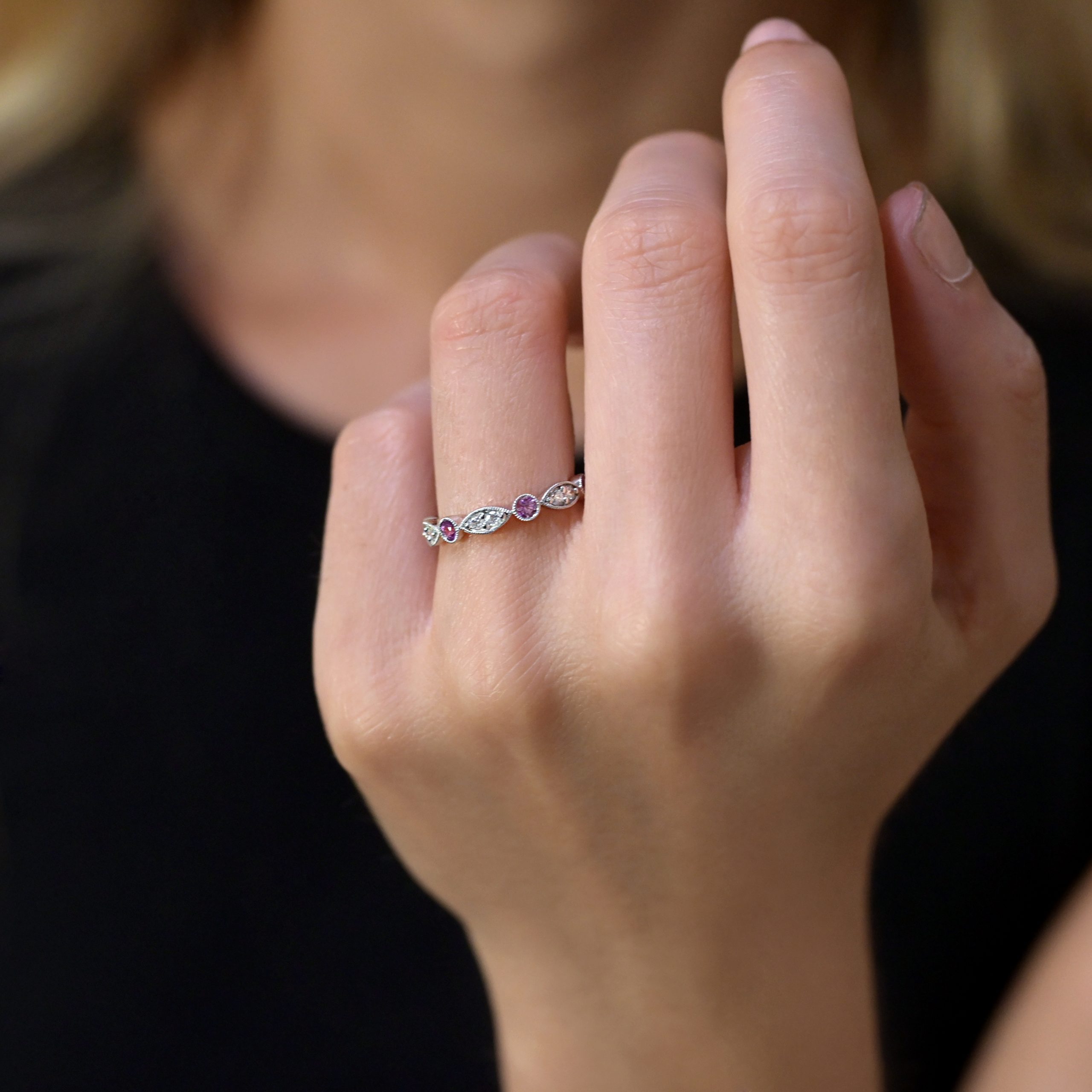 Diamond wedding ring with pink sapphires in 18kt gold.