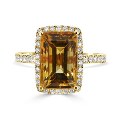 Yellow citrine and diamond cocktail ring in 18kt yellow gold with emerald-cut citrine and diamond halo.