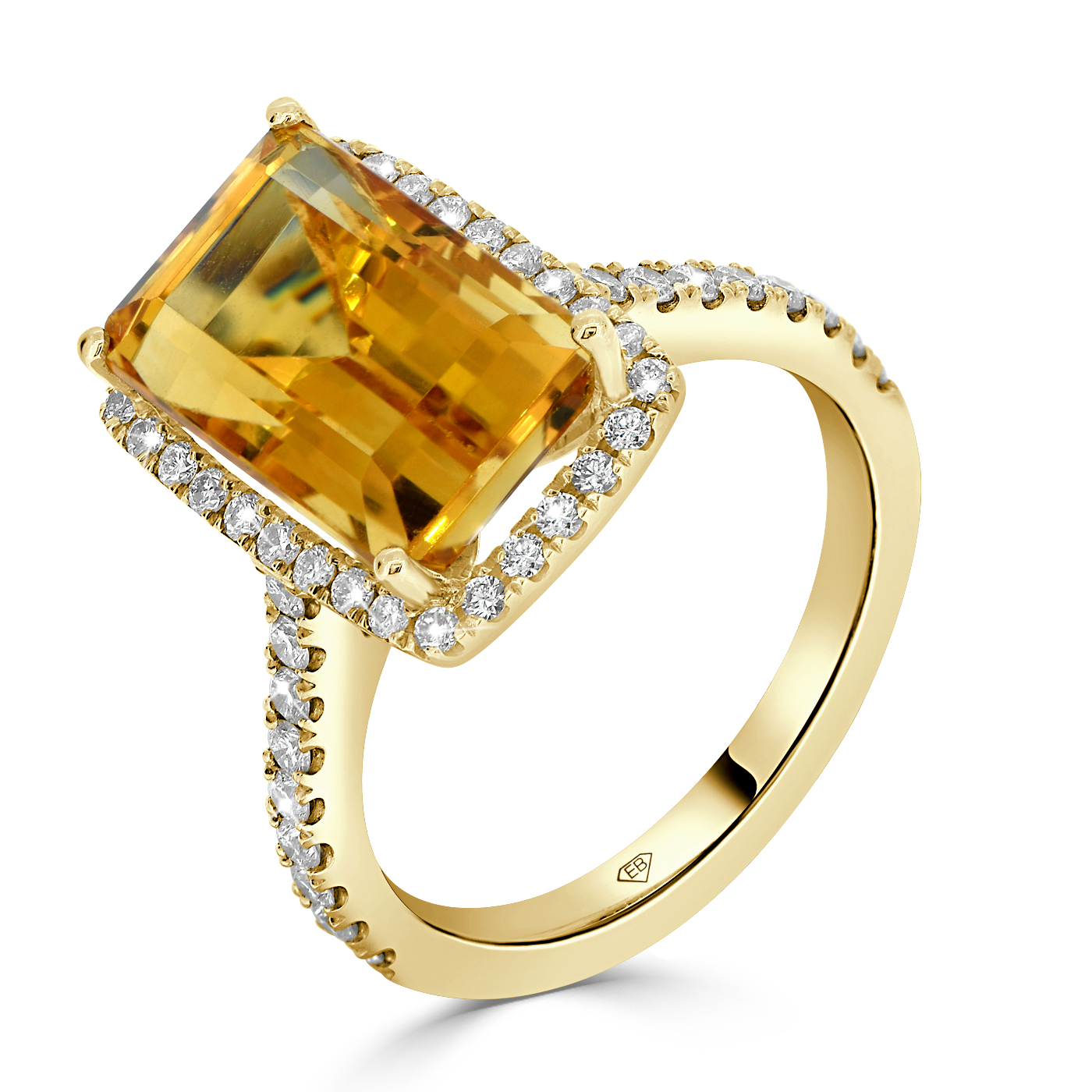 Yellow citrine and diamond cocktail ring in 18kt yellow gold with emerald-cut citrine and diamond halo.