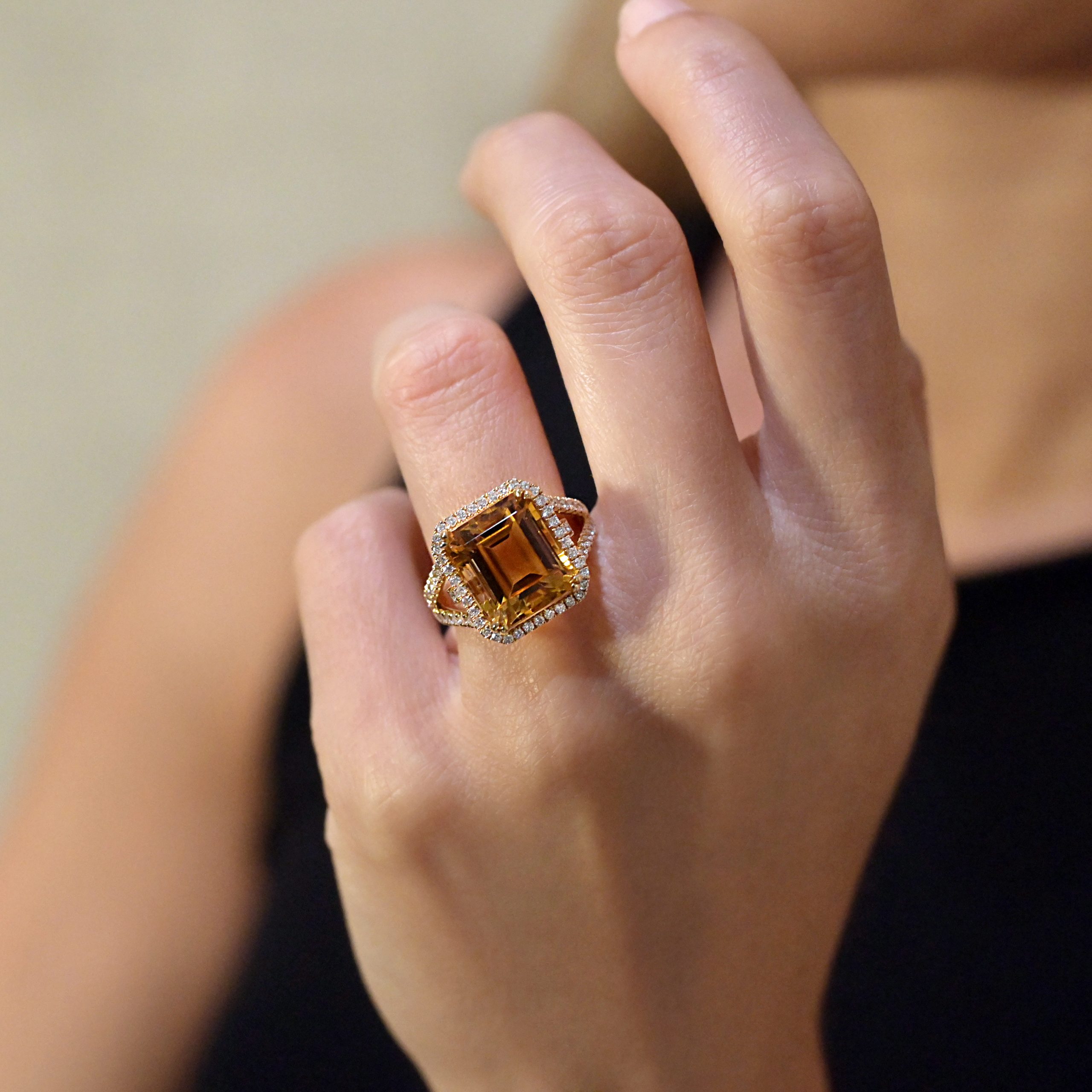 Yellow citrine and diamond cocktail ring in 18kt yellow gold with emerald-cut citrine and diamond halo.