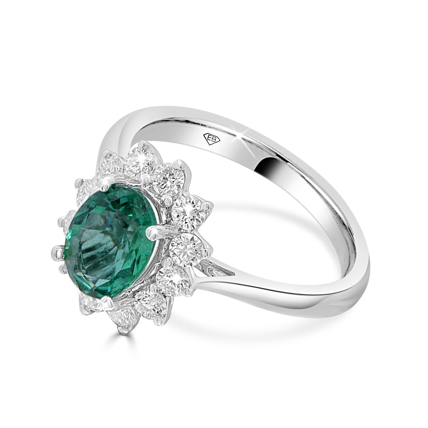 Emerald ring in 18kt white gold featuring a 1.13ct oval emerald surrounded by a diamond halo.